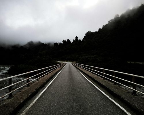 A winding path in a quiet forest, symbolizing a slow journey.
